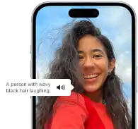 iPhone 15 showing Voiceover feature announcing the picture information, A person with wavy black hair laughing
